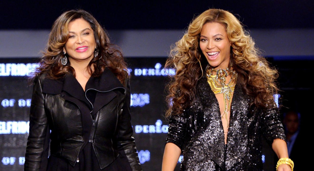 Beyonce and mother, Tina Knowles pictured on ENTITY walking hand in hand down the runway in 2011.