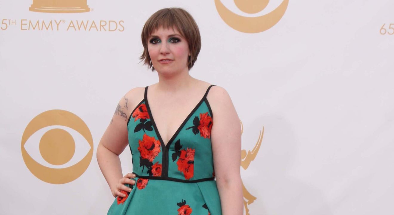 Entity reports on Lena Dunham cover story about impostor syndrome and how she's proud of her cellulite.