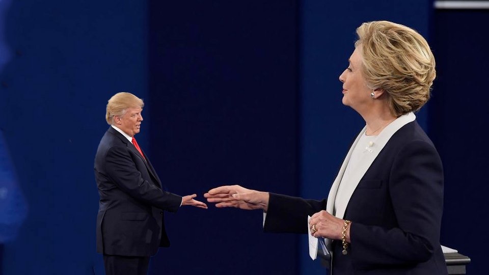 Entity reports on how small Tiny Trump looks beside Hillary Clinton.