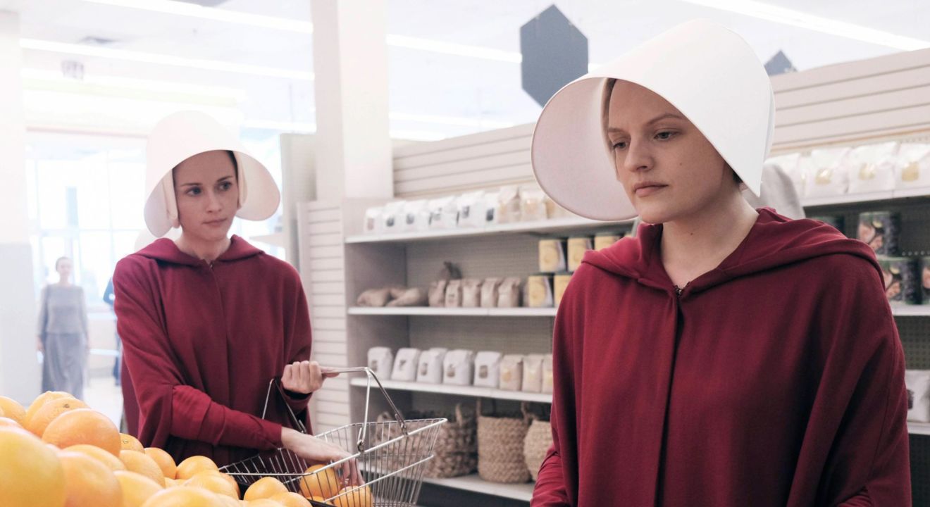 The Handmaid's Tale -- "Offred" -- Episode 101 -- Offred, one the few fertile women known as Handmaids in the oppressive Republic of Gilead, struggles to survive as a reproductive surrogate for a powerful Commander and his resentful wife. Ofglen (Alexis Bledel) and Offred (Elisabeth Moss), shown. (Photo by: George Kraychyk/Hulu)
