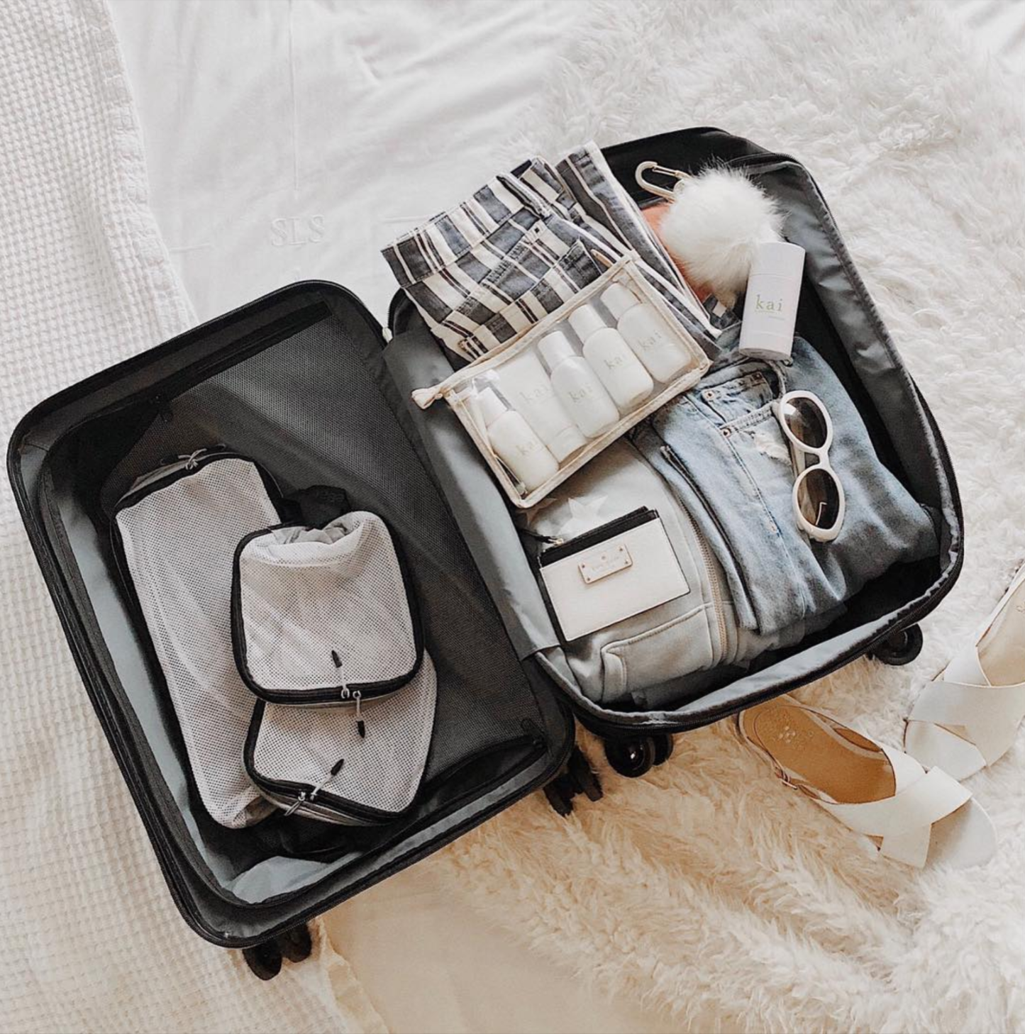 Photo of the inside of luggage. ENTITY shares why travel-sized bottles are one of the best Amazon products for travelers.
