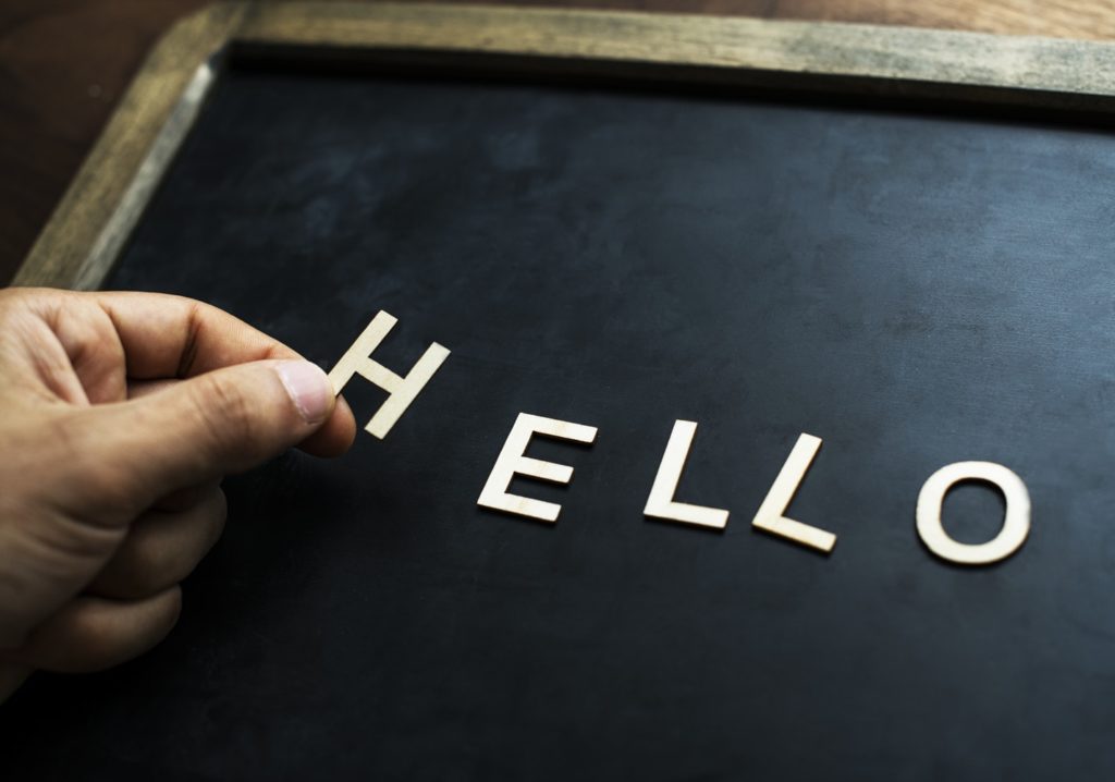 ENTITY explains when and how to follow up on a job application. Photo of a blackboard with the word "HELLO."