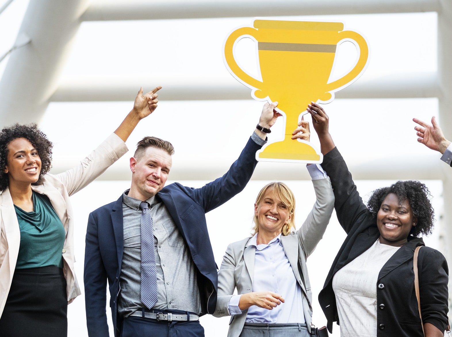 ENTITY shares three job interview mistakes to avoid. Photo of group holding a paper trophy.