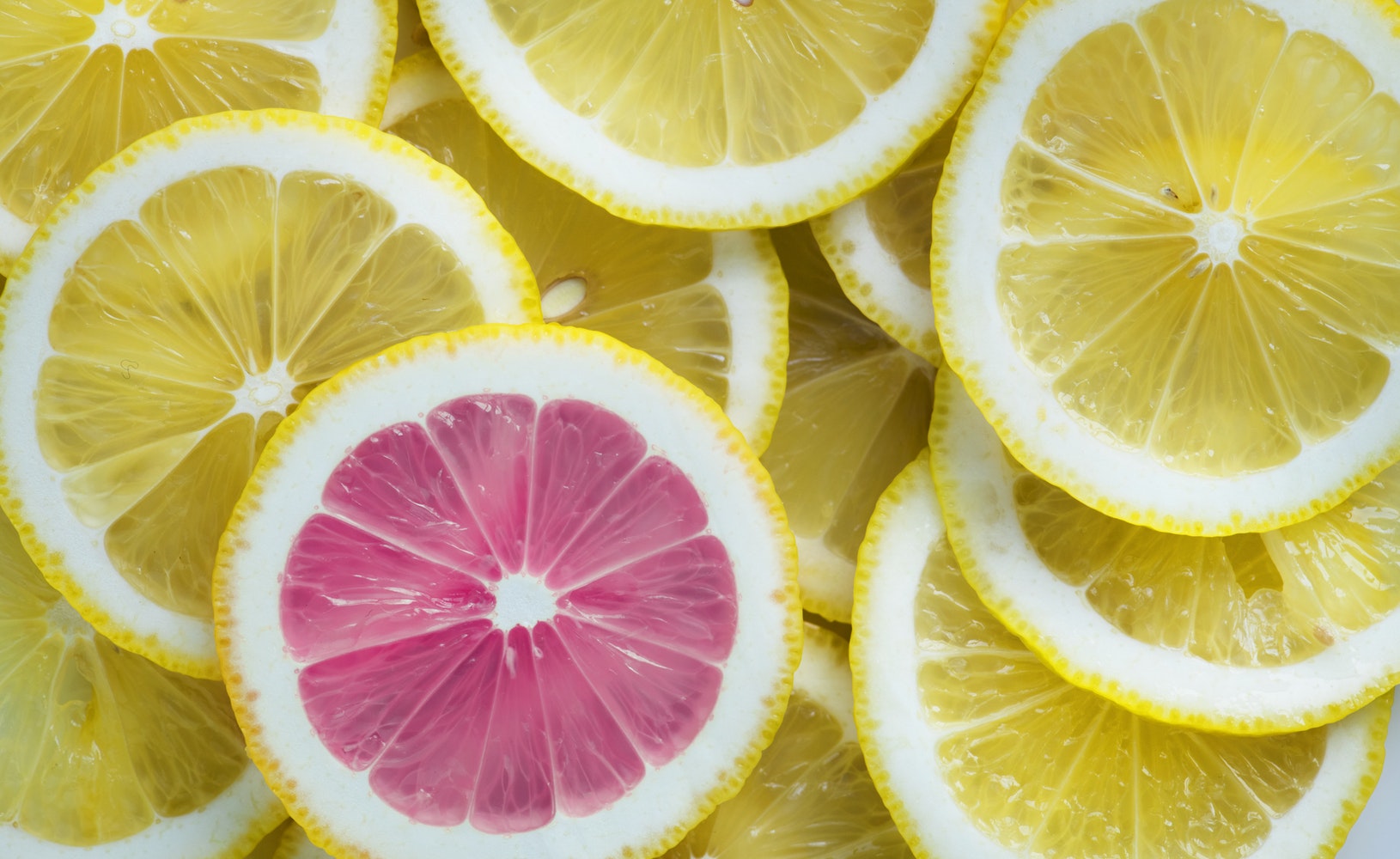 ENTITY shares LinkedIn profile tips. Photo of one pink lemon among many yellow lemons.