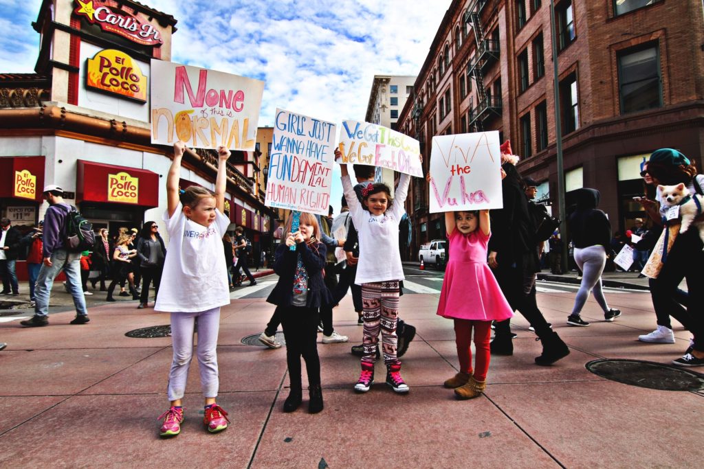 Young children protesting in the street why reproductive rights are important.