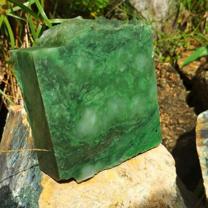 Photo of a green jade stone outdoors.
