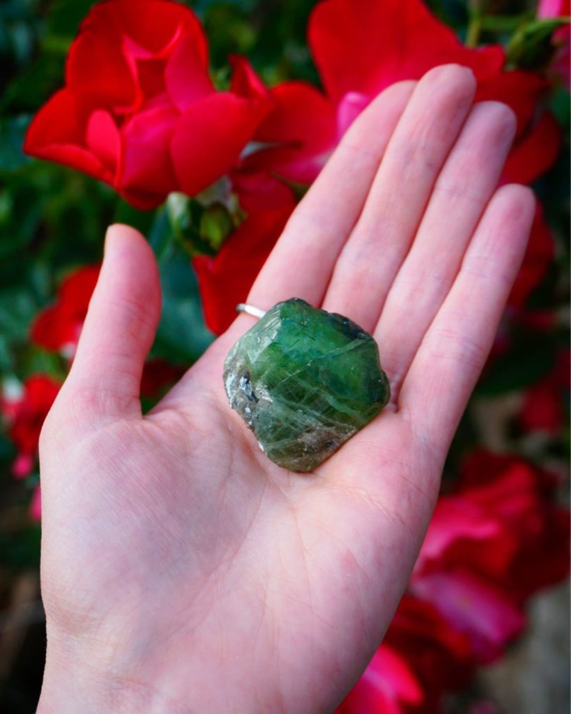 Image of a hand holding a peridot.