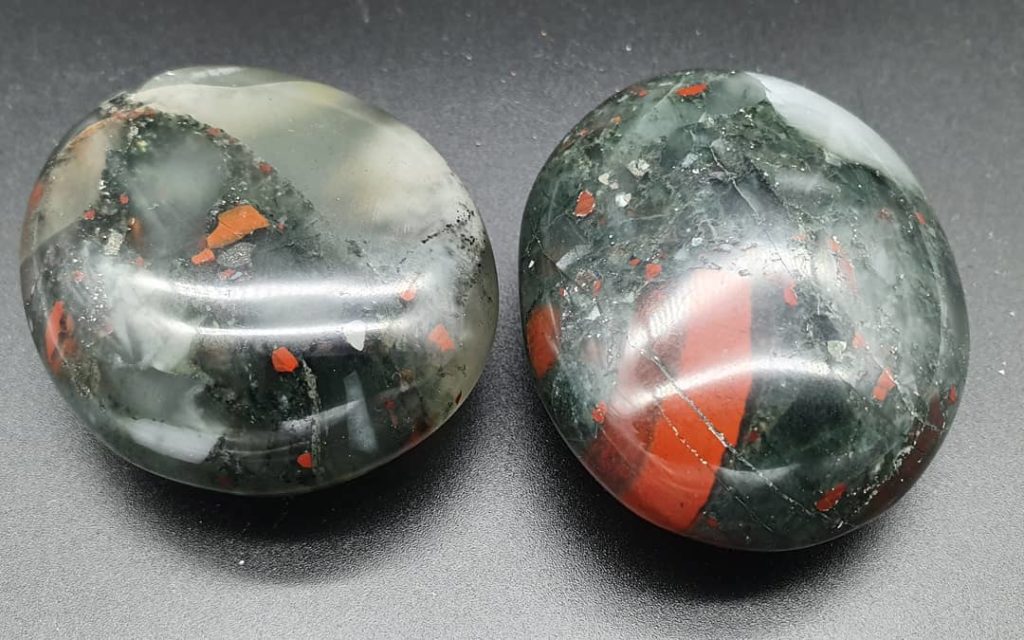 Photo of two multi-colored bloodstones. 