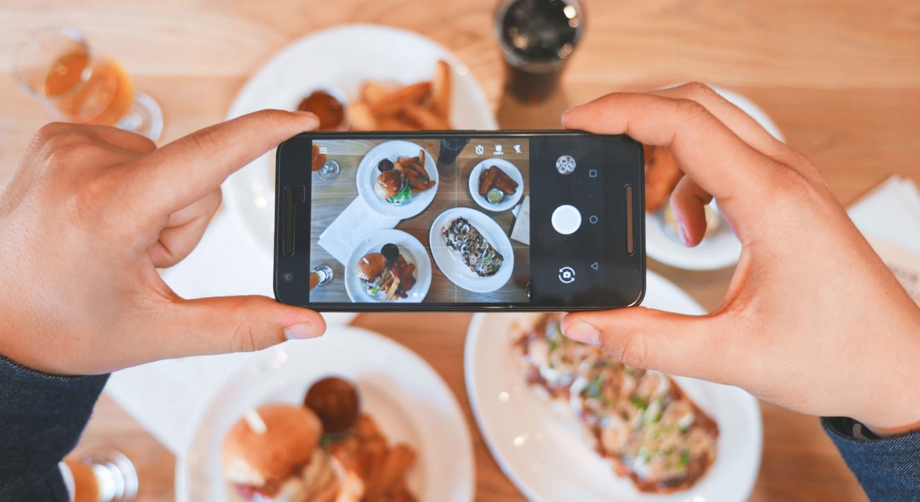 ENTITY shares photo of someone photographing food.