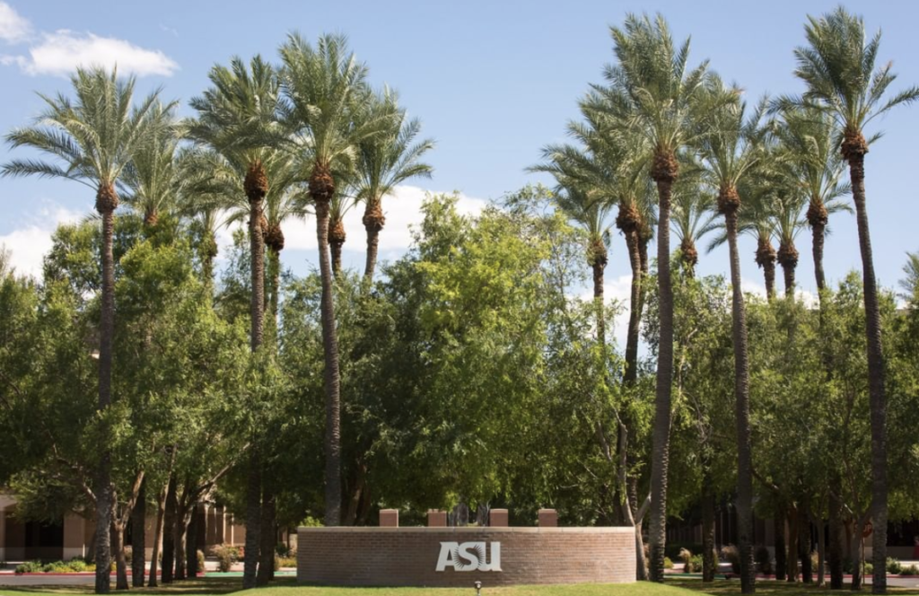A picture of ASU campus with palm trees in the front.
