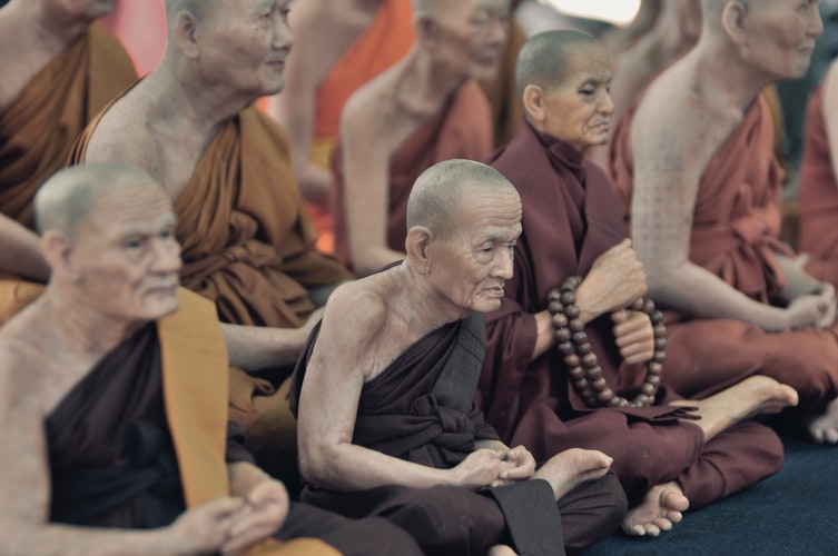 Monks meditating, similar to origin of yoga