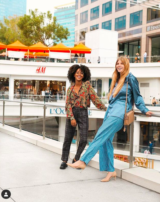 Entity shares photo of fun things to do in downtown LA- Women smiling at FIGat7th
