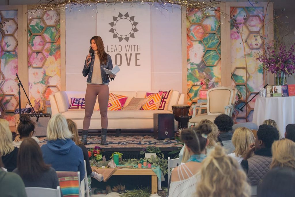 Lead With Love founder Gina Murdock talking at an event. 