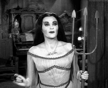 ENTITY Mag shares a gif of Lily Munster with a pitchfork - an idea for your halloween queen zodiac