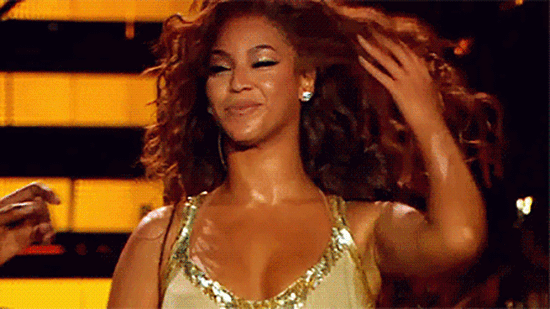 Gif of Beyonce tossing her hair and smiling on stage. 