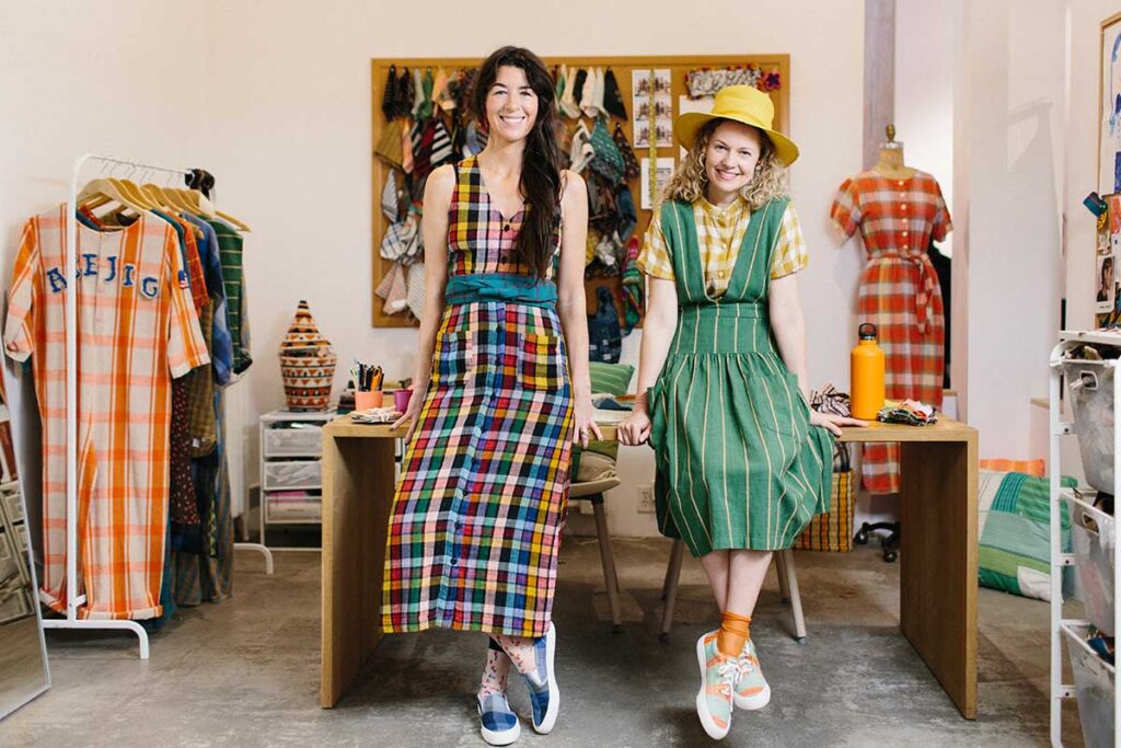 Sustainable fashion brand Ace & Jig models wearing colorful dresses.